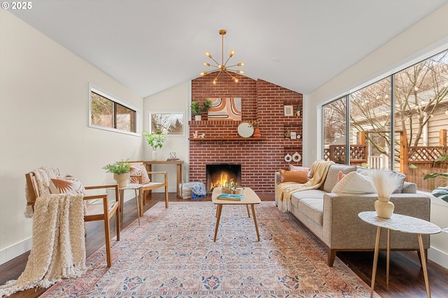 living area with lofted ceiling, a healthy amount of sunlight, an inviting chandelier, and wood finished floors