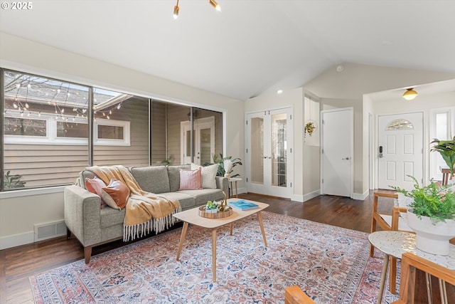 living room with lofted ceiling, wood finished floors, visible vents, baseboards, and french doors