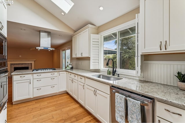 1722 Sequoia Ct, Forest Grove, OR 97116 - kitchen with stainless steel appliances, island range hood, a skylight, vaulted ceiling, and a peninsula
