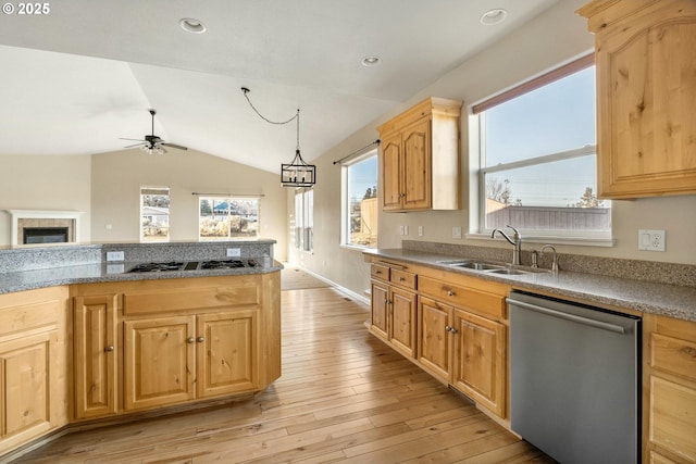 kitchen with lofted ceiling, sink, decorative light fixtures, stainless steel dishwasher, and black gas stovetop