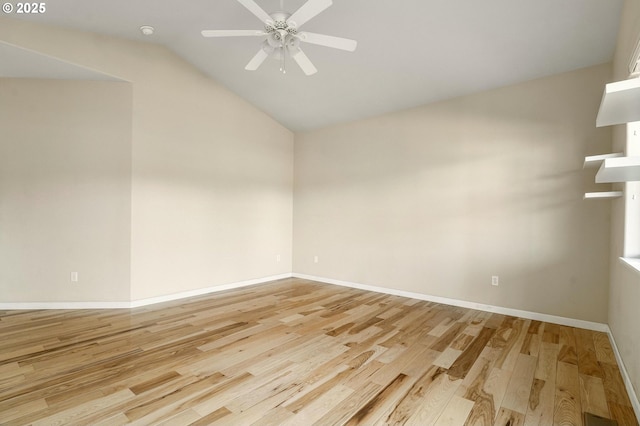 empty room with vaulted ceiling, ceiling fan, and light wood-type flooring