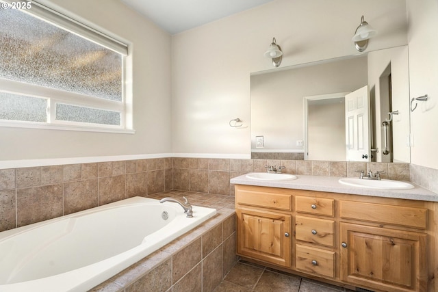 bathroom with vanity, tiled bath, and tile patterned floors