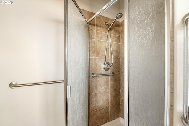 bathroom with a shower with door