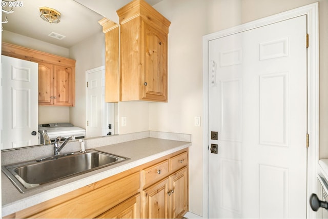 kitchen with sink, washer / clothes dryer, and light brown cabinets