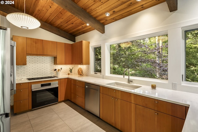 610 Atwater Rd, Lake Oswego, OR 97034 - kitchen with stainless steel appliances, a sink, decorative backsplash, light countertops, and light tile patterned floors