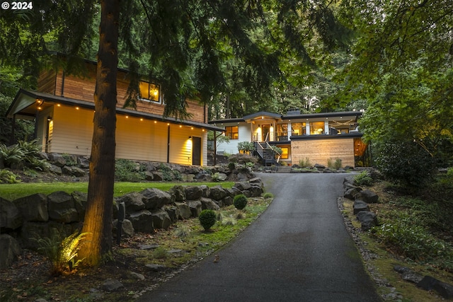 view of front of house featuring driveway and stairs