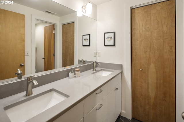 full bath featuring visible vents, a sink, and double vanity