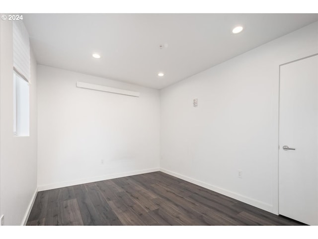 unfurnished room with recessed lighting, dark wood finished floors, and baseboards