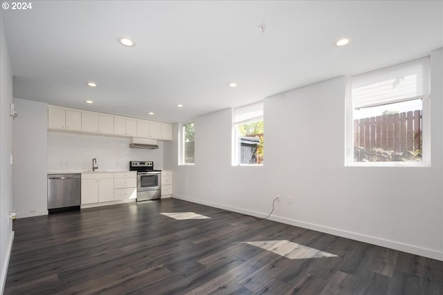 1480 N Jarrett St Unit 103, Portland, OR 97217 - kitchen featuring dark wood-style flooring, appliances with stainless steel finishes, white cabinetry, recessed lighting, and under cabinet range hood