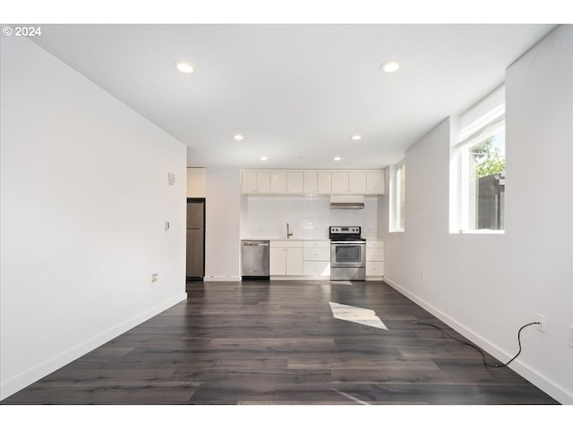 interior space with baseboards, recessed lighting, white cabinetry, dark wood finished floors, and stainless steel appliances