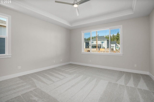 unfurnished room featuring crown molding, carpet flooring, ceiling fan, and a tray ceiling