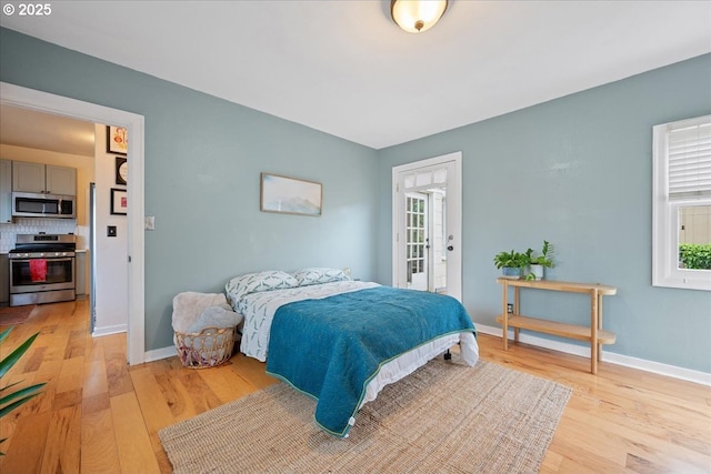 bedroom featuring light wood-style floors and baseboards