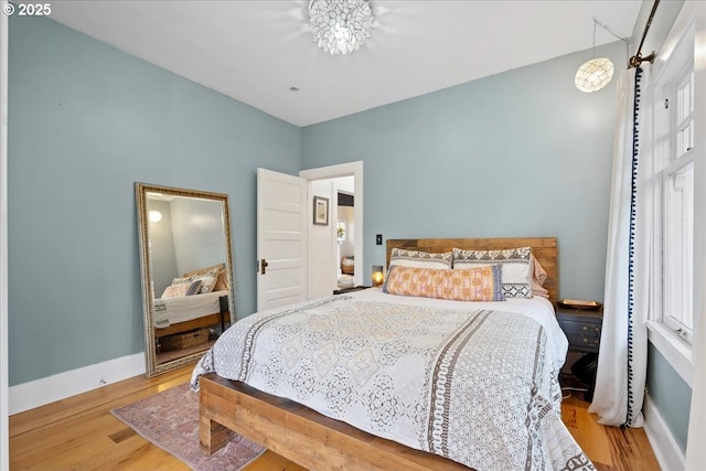bedroom featuring wood finished floors and baseboards