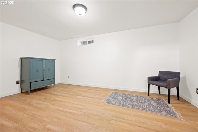 living area with light wood finished floors and baseboards