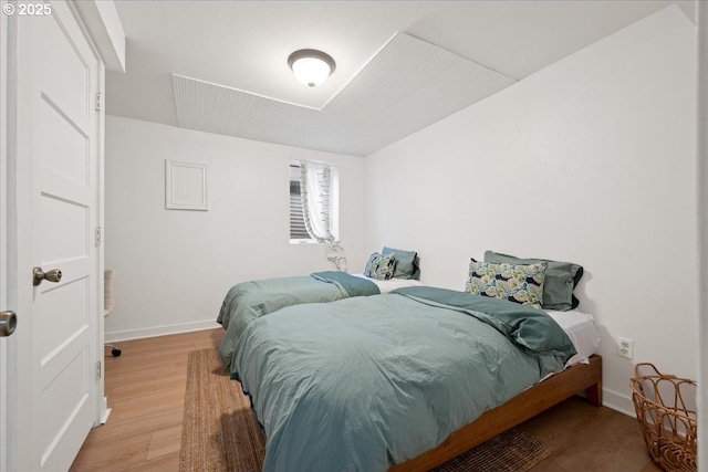bedroom featuring wood finished floors and baseboards