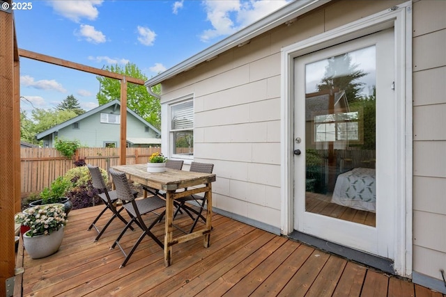 wooden deck featuring outdoor dining space and fence