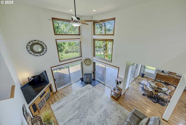 38201 Queens Rd, Marcola, OR 97454 - living room with ceiling fan, a towering ceiling, wood finished floors, baseboards, and recessed lighting