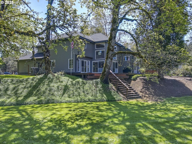 38201 Queens Rd, Marcola, OR 97454 - rear view of property featuring stairs, a lawn, central air condition unit, and a deck