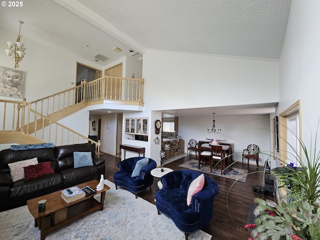 3300 NE 164th St Unit S-1, Ridgefield, WA 98642 - living area featuring wood finished floors, a textured ceiling, stairs, high vaulted ceiling, and a chandelier