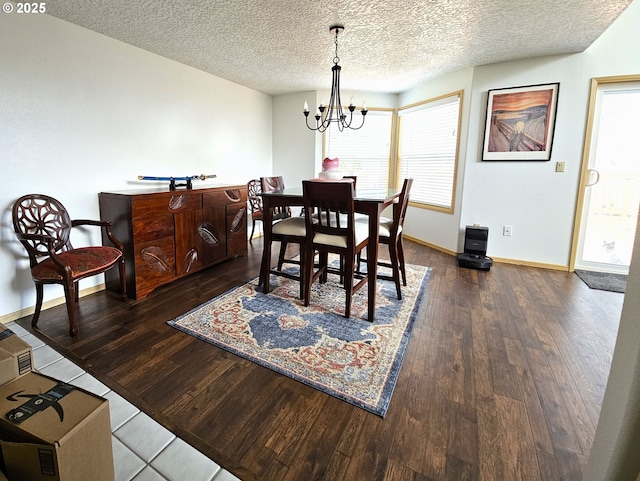 3300 NE 164th St Unit S-1, Ridgefield, WA 98642 - dining space featuring a chandelier, dark wood-style flooring, plenty of natural light, a textured ceiling, and baseboards