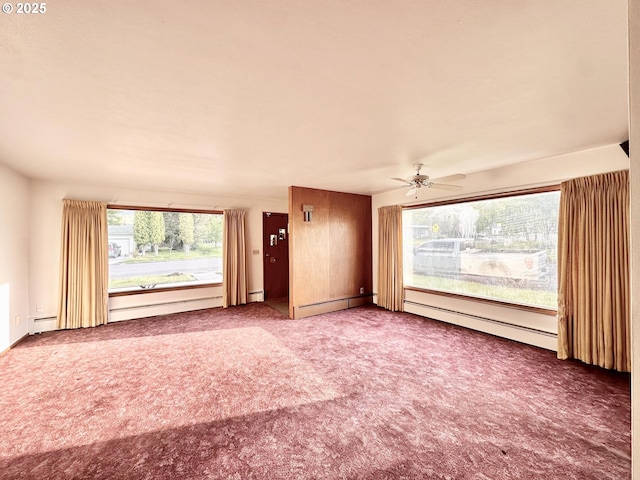 901 H Ave, La Grande, OR 97850 - unfurnished living room with baseboard heating, carpet flooring, ceiling fan, and a baseboard radiator
