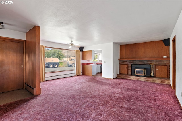 901 H Ave, La Grande, OR 97850 - unfurnished living room featuring a brick fireplace, a baseboard radiator, carpet floors, a ceiling fan, and wood walls