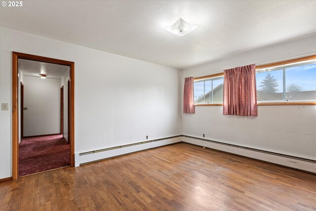 901 H Ave, La Grande, OR 97850 - empty room featuring wood finished floors, baseboard heating, and baseboards