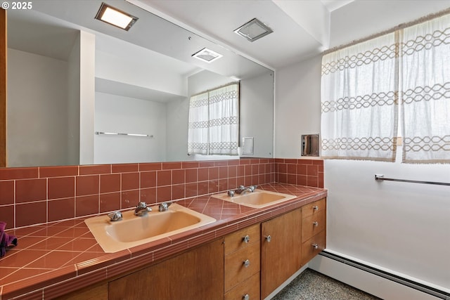 901 H Ave, La Grande, OR 97850 - full bathroom with a baseboard heating unit, decorative backsplash, speckled floor, and double vanity