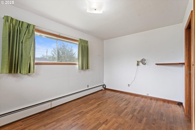 901 H Ave, La Grande, OR 97850 - spare room featuring a baseboard heating unit, wood finished floors, and baseboards