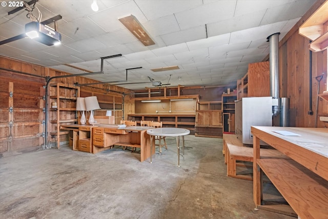 901 H Ave, La Grande, OR 97850 - garage featuring a workshop area, a garage door opener, and wooden walls