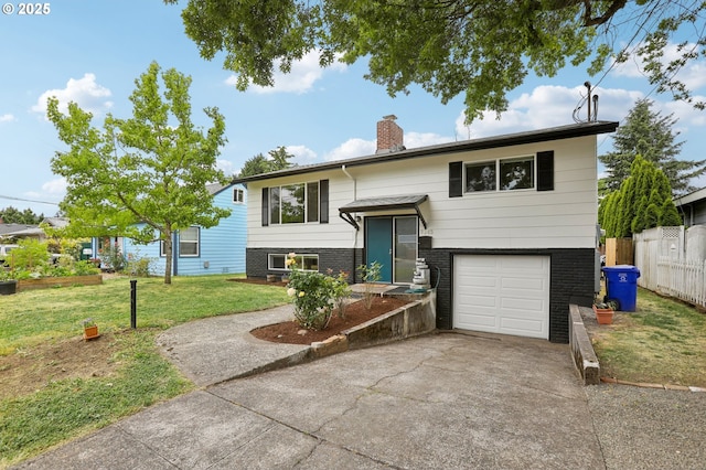 split foyer home with a garage and a front yard