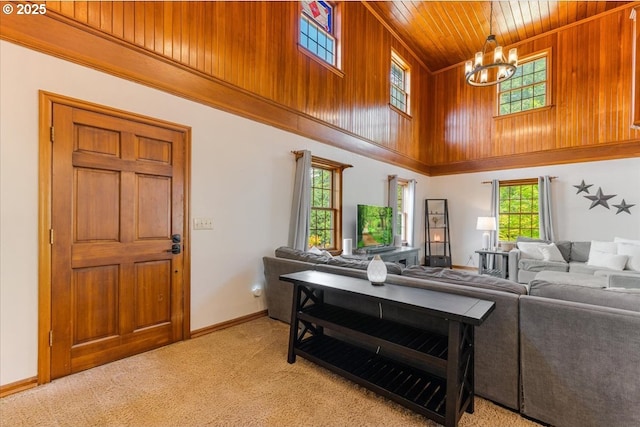 26127 NW Williams Canyon Rd, Gaston, OR 97119 - living room with a high ceiling, wood ceiling, a chandelier, light colored carpet, and baseboards