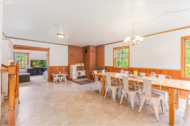 26127 NW Williams Canyon Rd, Gaston, OR 97119 - dining space featuring wainscoting, wood walls, a chandelier, and crown molding