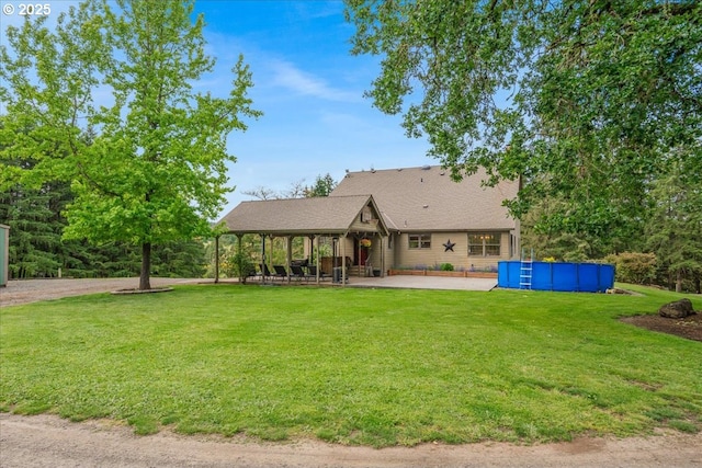 26127 NW Williams Canyon Rd, Gaston, OR 97119 - view of front of home with an outdoor pool, a front lawn, a patio area, and a shingled roof
