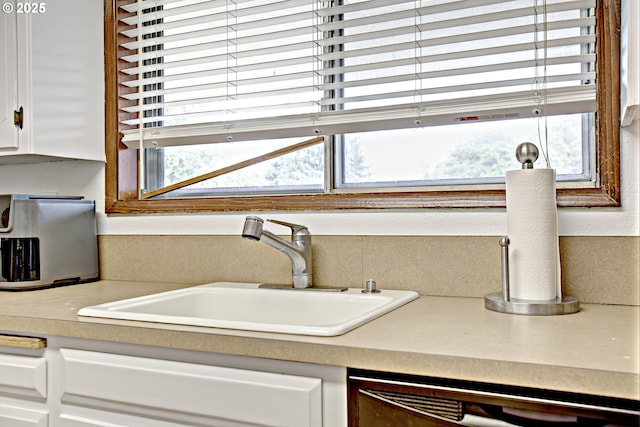 21408 SE Main St, Gresham, OR 97030 - kitchen view of a sink, dishwasher, white cabinetry, and light countertops