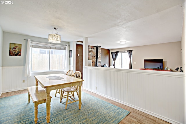 21408 SE Main St, Gresham, OR 97030 - dining room featuring wood finished floors, a textured ceiling, and a wainscoted wall