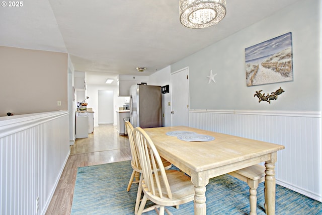 21408 SE Main St, Gresham, OR 97030 - dining space featuring a wainscoted wall, light wood-style floors, and a chandelier