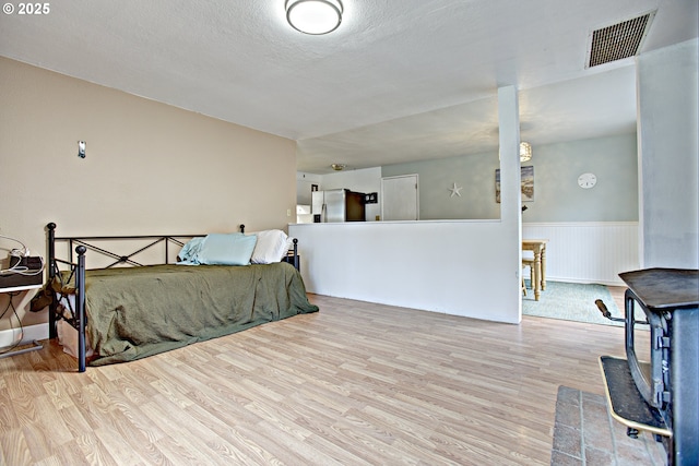 21408 SE Main St, Gresham, OR 97030 - bedroom featuring stainless steel fridge with ice dispenser, wood finished floors, wainscoting, and a textured ceiling