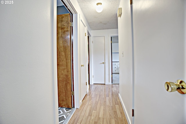 21408 SE Main St, Gresham, OR 97030 - hall with a textured ceiling, light wood-type flooring, and baseboards