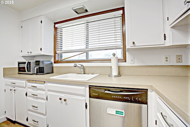 21408 SE Main St, Gresham, OR 97030 - kitchen with dishwasher, a sink, white cabinets, and light countertops