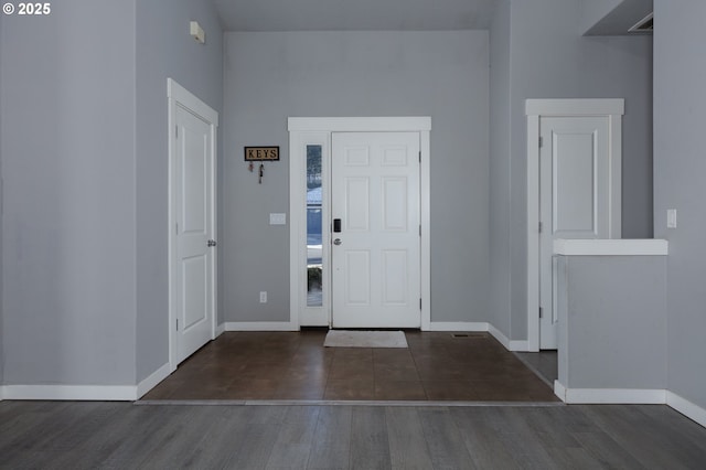 foyer entrance featuring wood finished floors and baseboards