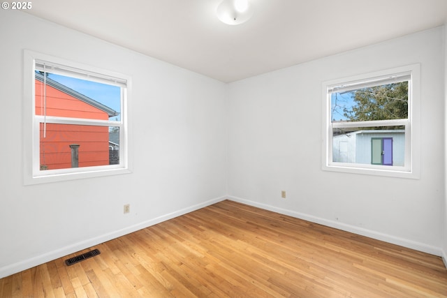 unfurnished room featuring hardwood / wood-style floors