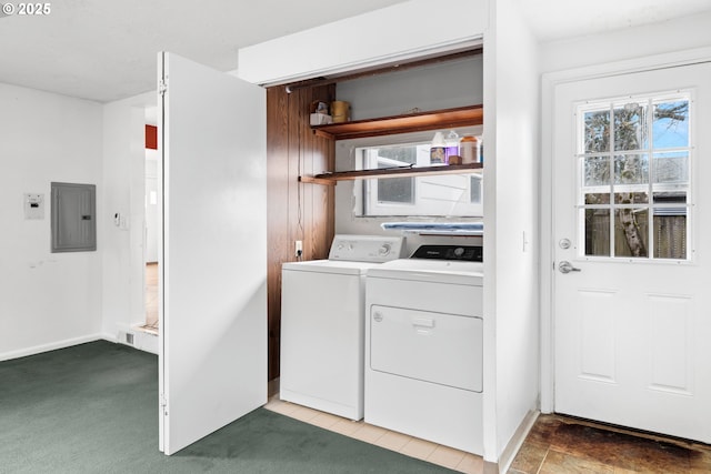 washroom with electric panel, washer and dryer, and carpet flooring