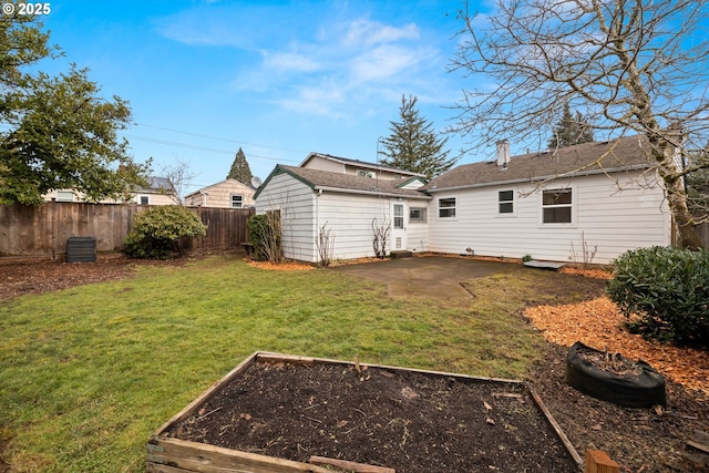 back of house with a yard, a patio area, and an outdoor structure