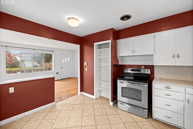 kitchen featuring white cabinetry, stainless steel electric stove, and light tile patterned floors