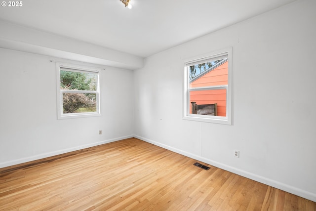 empty room with light hardwood / wood-style floors