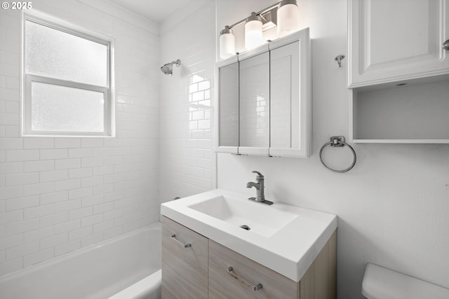 full bathroom with vanity, toilet, and tiled shower / bath combo