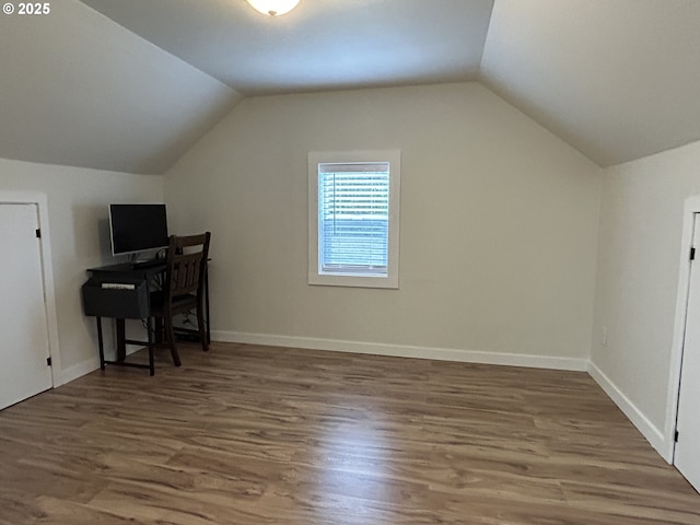 home office featuring dark wood-style floors, lofted ceiling, and baseboards