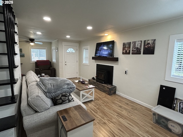 living area featuring recessed lighting, ceiling fan, baseboards, and wood finished floors