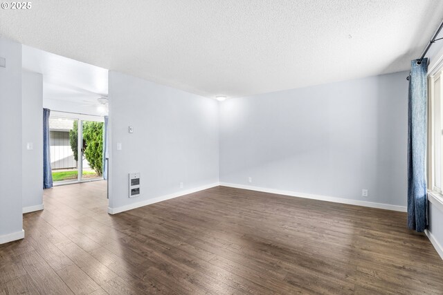 5304 NE 84th Loop Unit 16, Vancouver, WA 98662 - spare room with heating unit, dark wood-type flooring, a textured ceiling, baseboards, and a ceiling fan